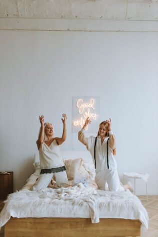 2 Women Sitting on Bed