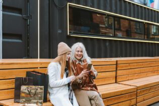 Woman in White Coat Sitting on Brown Wooden Bench